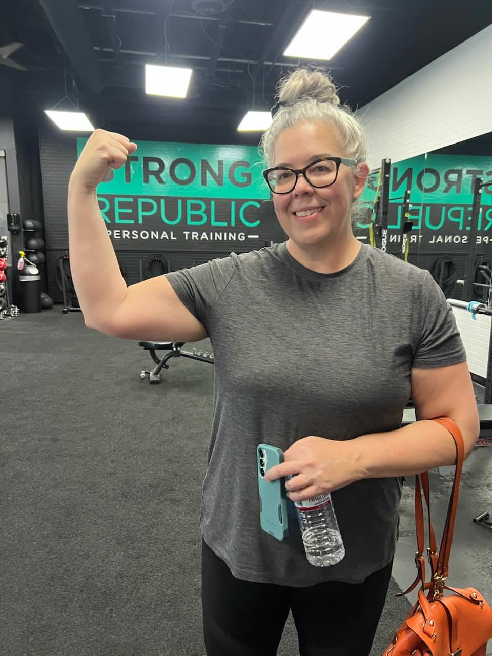 A La Quinta member showing off her arm strength after training at Strong Republic